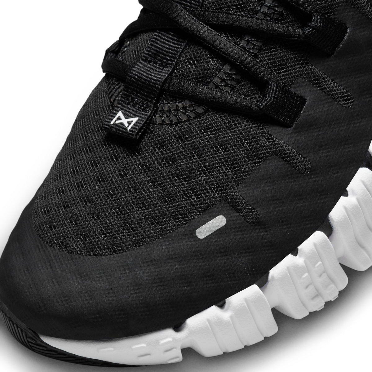 Nike Men's Free Metcon 5 black and white training shoes, side view, by Denim Exchange