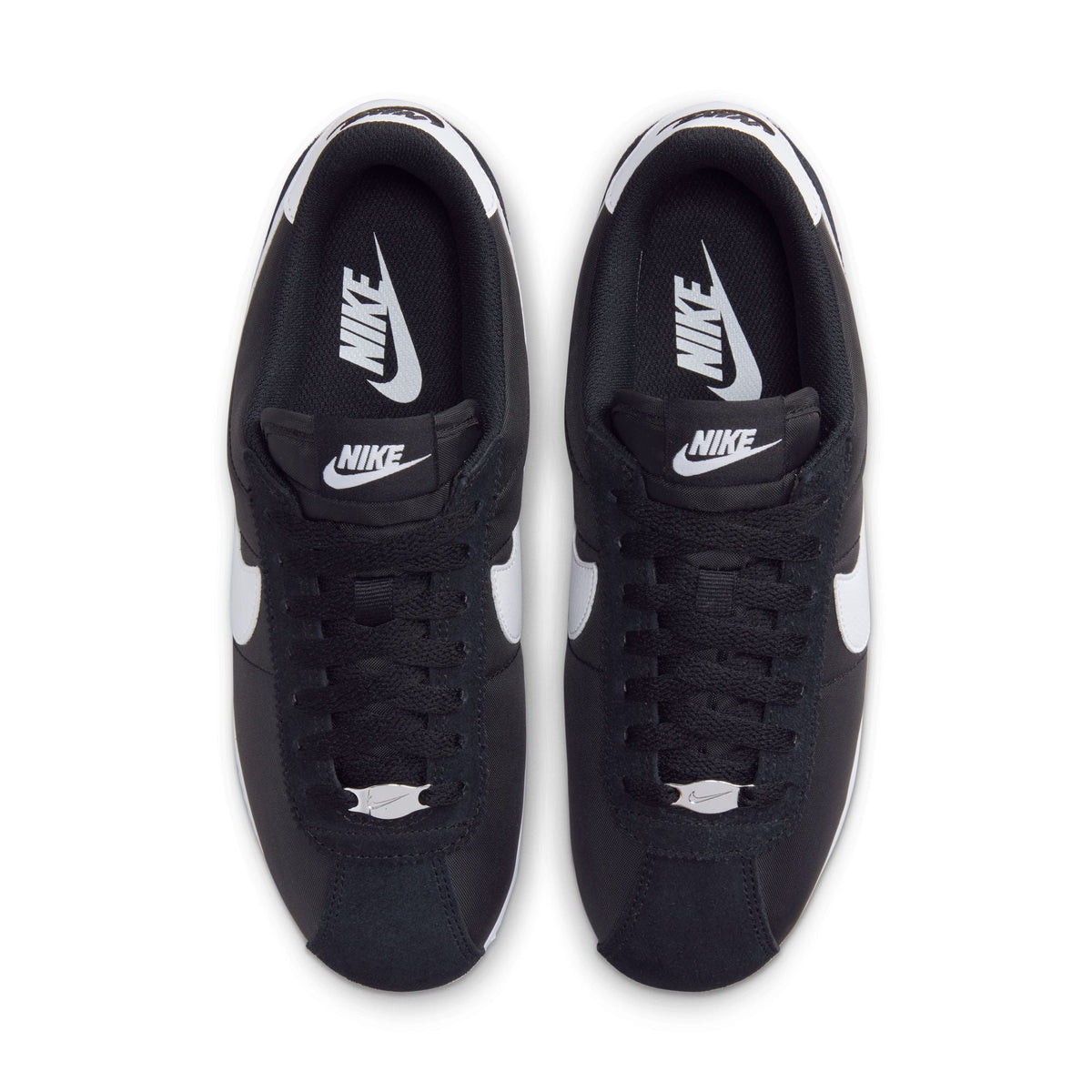 Black and white Nike Women's Cortez sneakers featuring classic design and clean style, shown on a plain background.