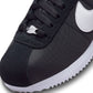 Nike Womens Cortez sneakers in black and white, showcasing classic design with white laces and Nike branding on the side.