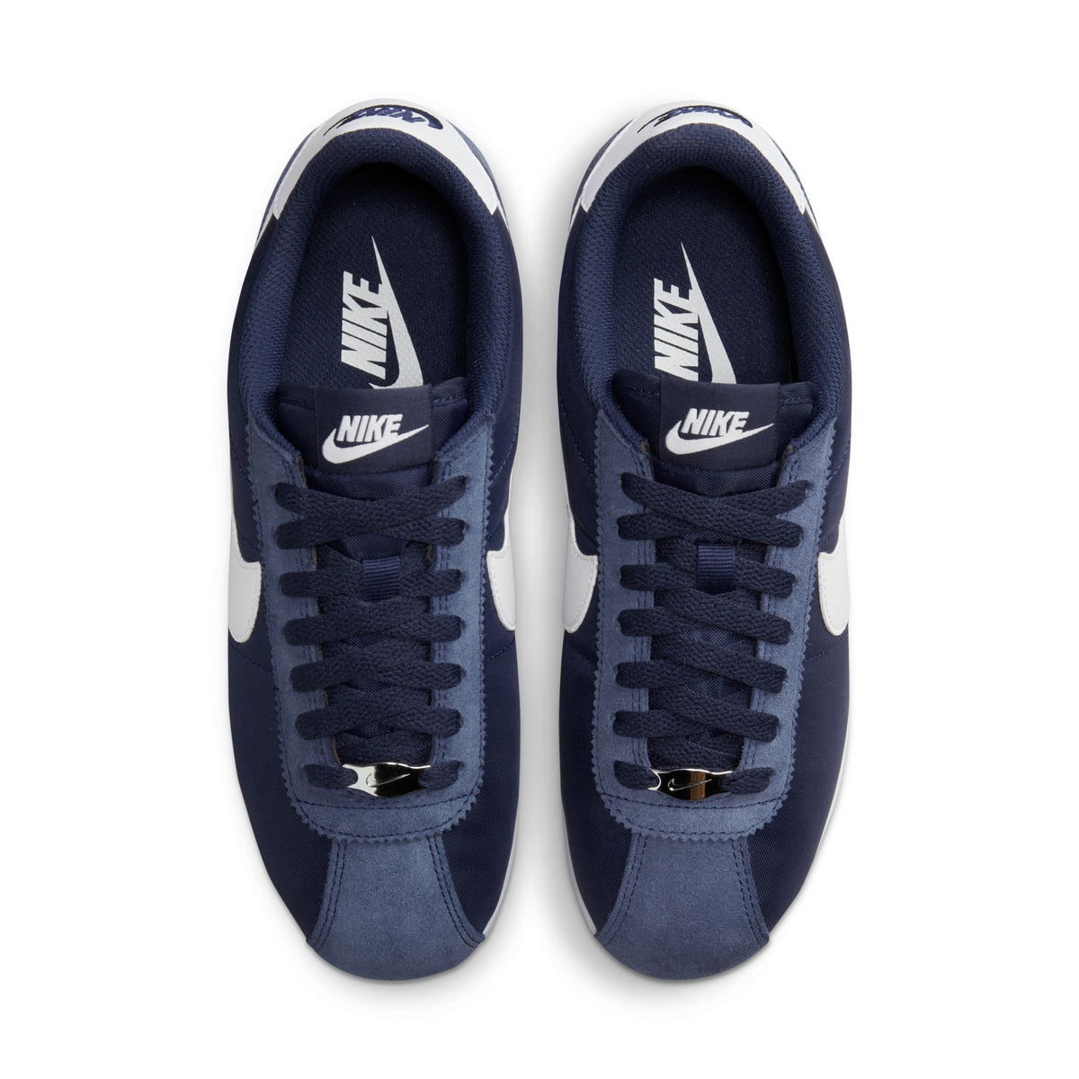 Nike Womens Cortez Midnight Navy sneakers featuring white soles and navy blue fabric, styled for casual wear.