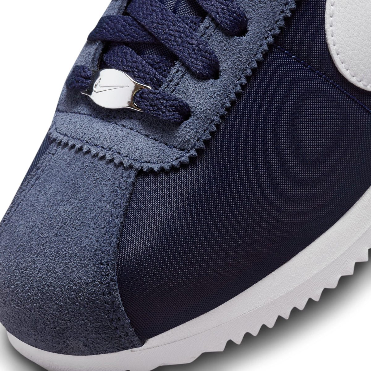 Nike Womens Cortez Midnight Navy athletic footwear with white sole and classic design, shown on a plain background.