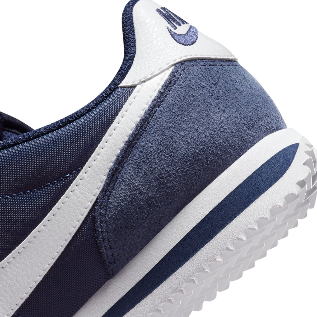 Nike Womens Cortez Midnight Navy athletic shoes with white soles and navy laces, designed for casual and athletic wear.