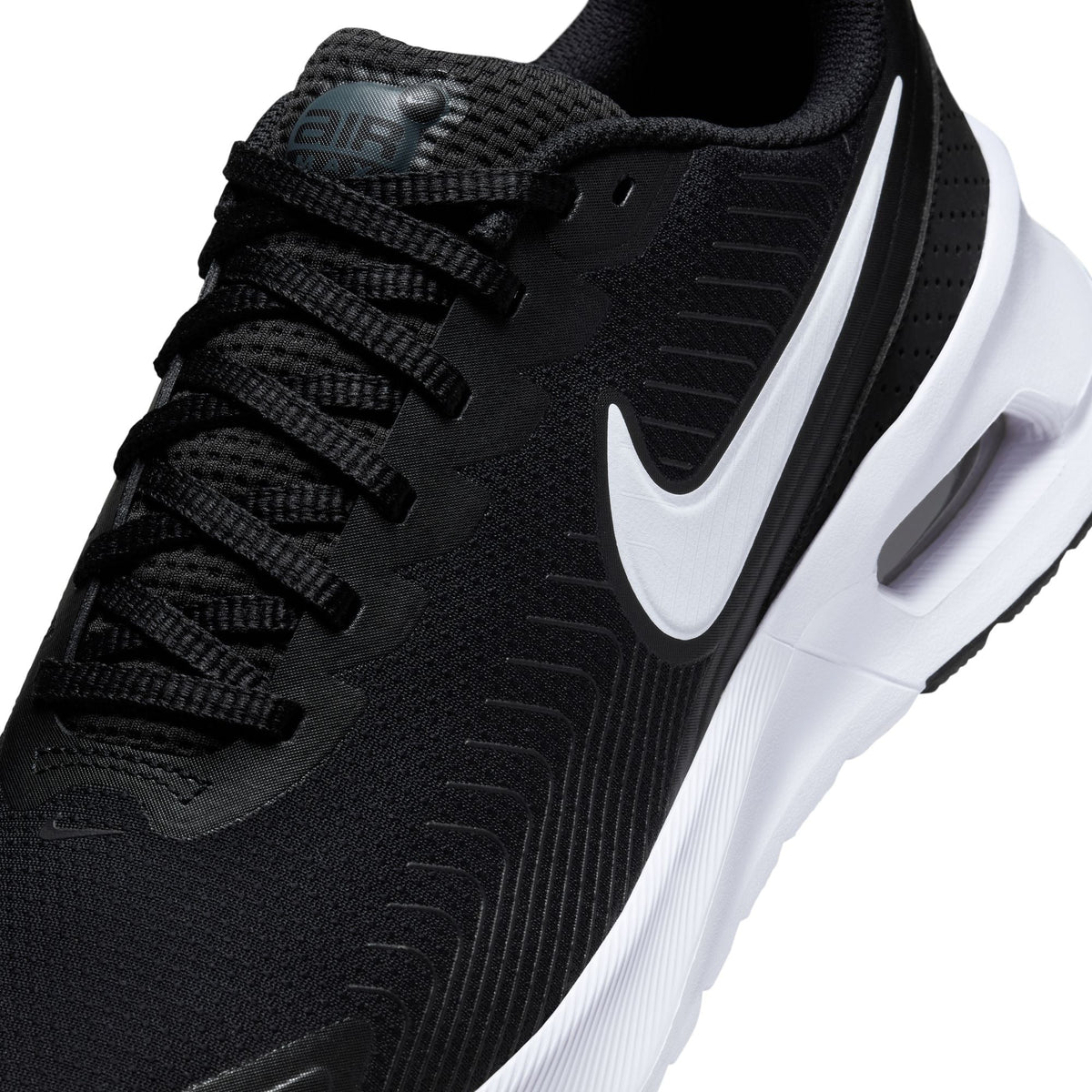 Nike Mens Air Max Nuaxis sneakers in black and white, showcasing the sleek design and athletic style of the Nike footwear.