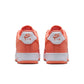 Nike Mens Air Force 1 '07 Orange Frost sneakers with white soles and orange accents, showcasing a classic athletic shoe design.