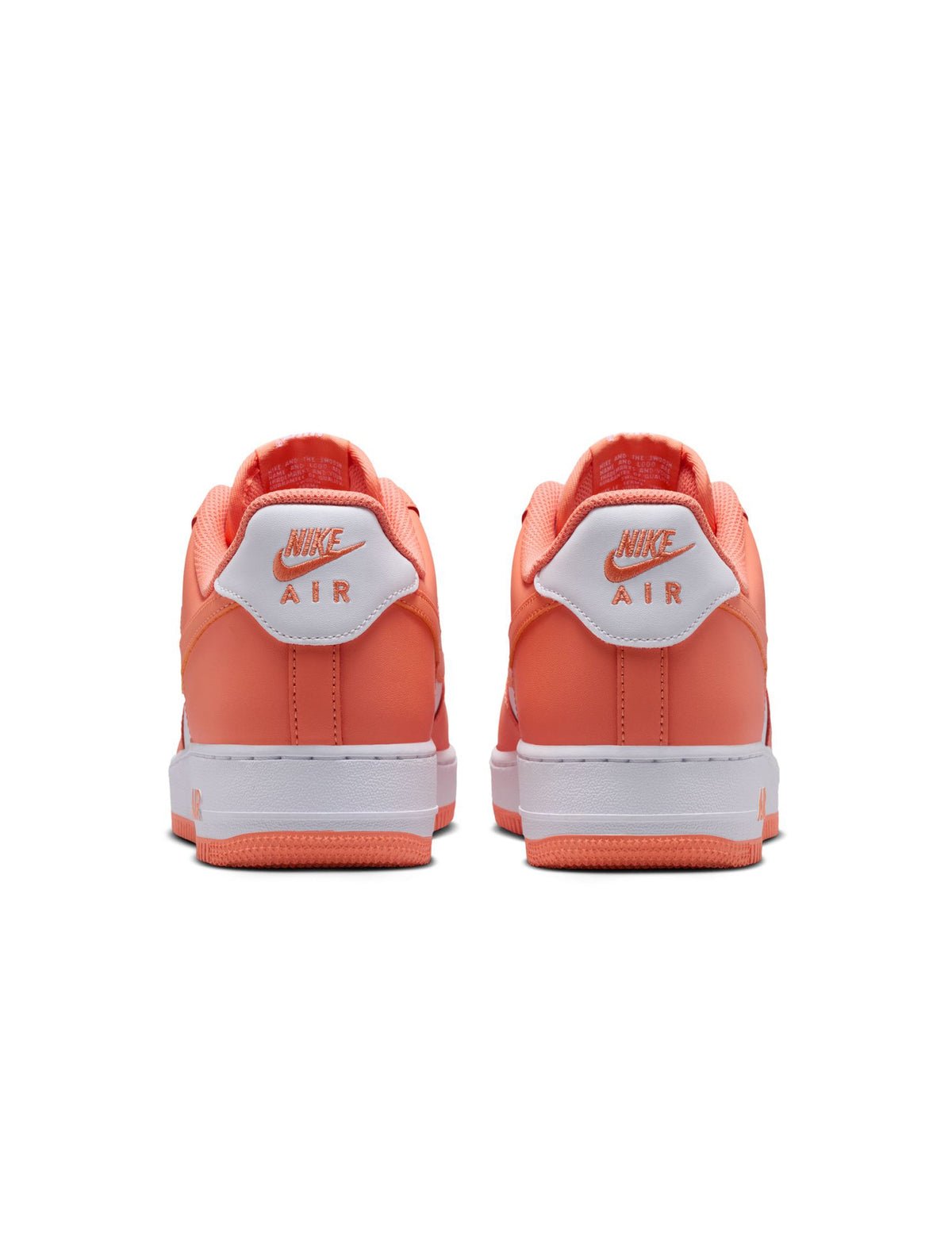 Nike Mens Air Force 1 '07 Orange Frost sneakers with white soles and orange accents, showcasing a classic athletic shoe design.