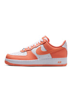 Nike Men's Air Force 1 '07 sneakers in Orange Frost, featuring a sleek design and classic Nike style.