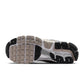 Nike Men's Zoom Vomero 5 sneakers in metallic silver, side view with layered mesh and reflective accents
