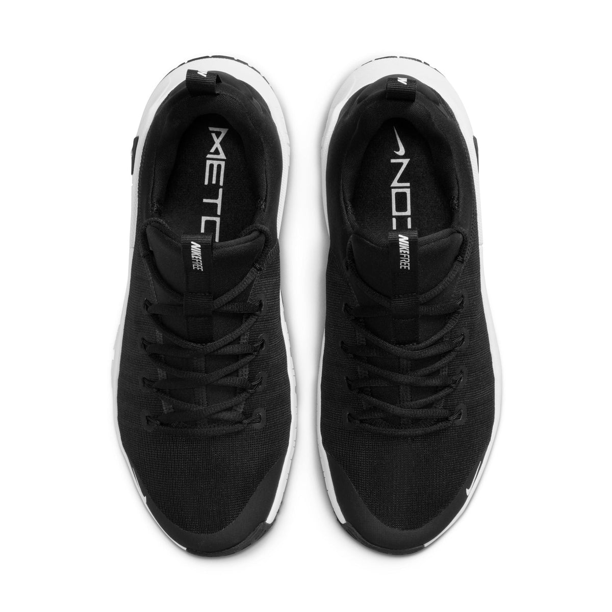 Nike Womens Free Metcon 6 athletic shoes in black and white, featuring lightweight design and flexible soles for training.