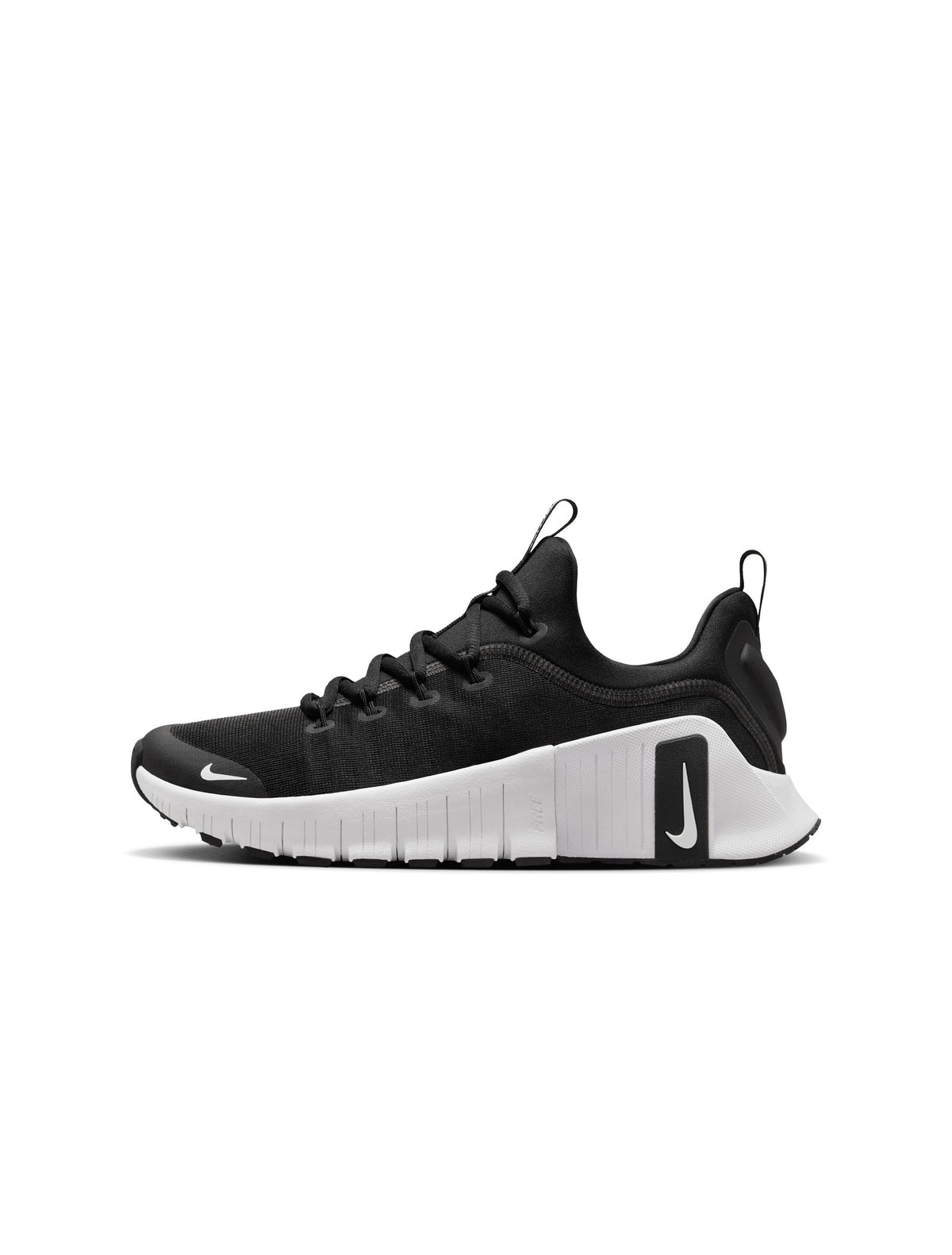 Nike Womens Free Metcon 6 running shoes in black and white, featuring lightweight design and flexible sole, shown from side view.