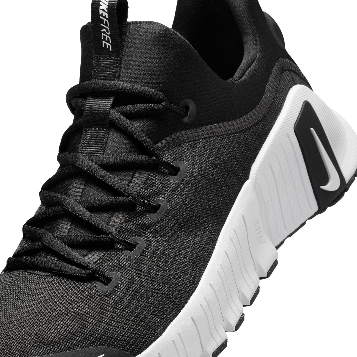 Nike Womens Free Metcon 6 black and white athletic footwear, showing the sleek design and lightweight construction.