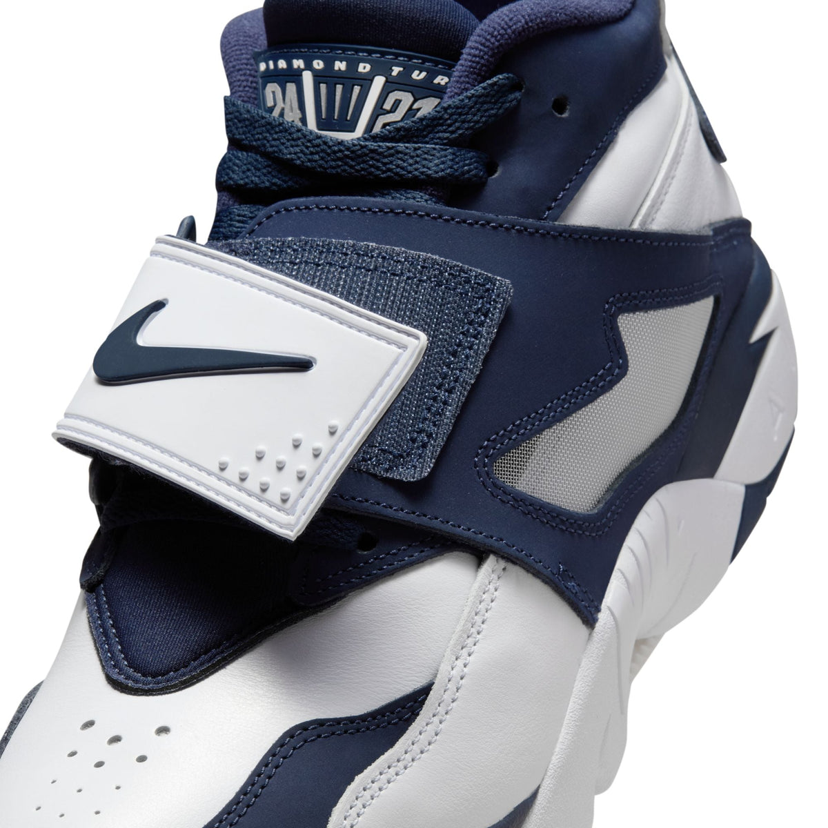 Nike Mens Air Diamond Turf Cowboys footwear in white and blue with Nike branding and signature design details.