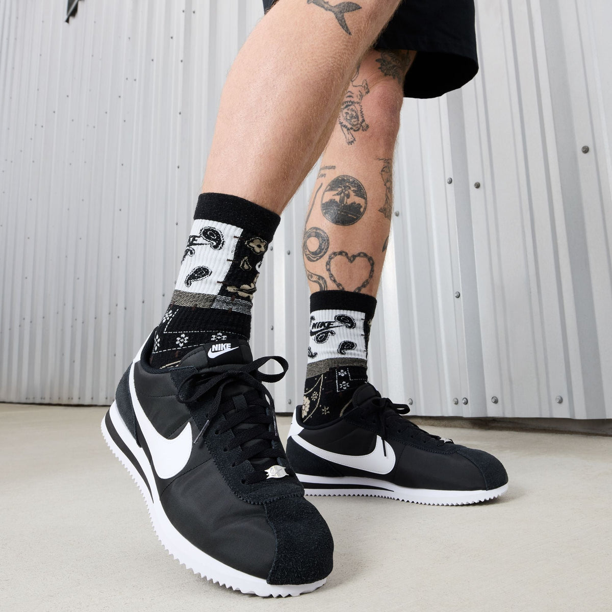 Nike Men's Cortez TXT black and white sneakers by Denim Exchange, side view