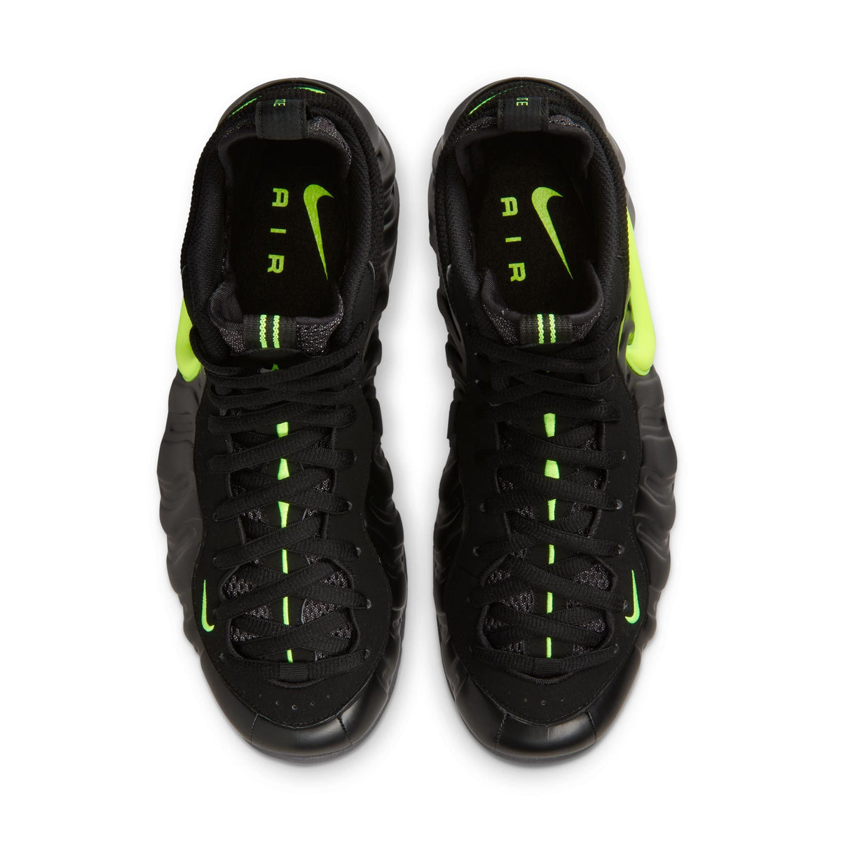 Nike men's Air Foamposite Pro sneakers in black and voltage with a sleek design and bold color accents.