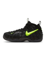 Nike men's Air Foamposite Pro sneakers in black and voltage, showcasing a sleek design with bold color accents.