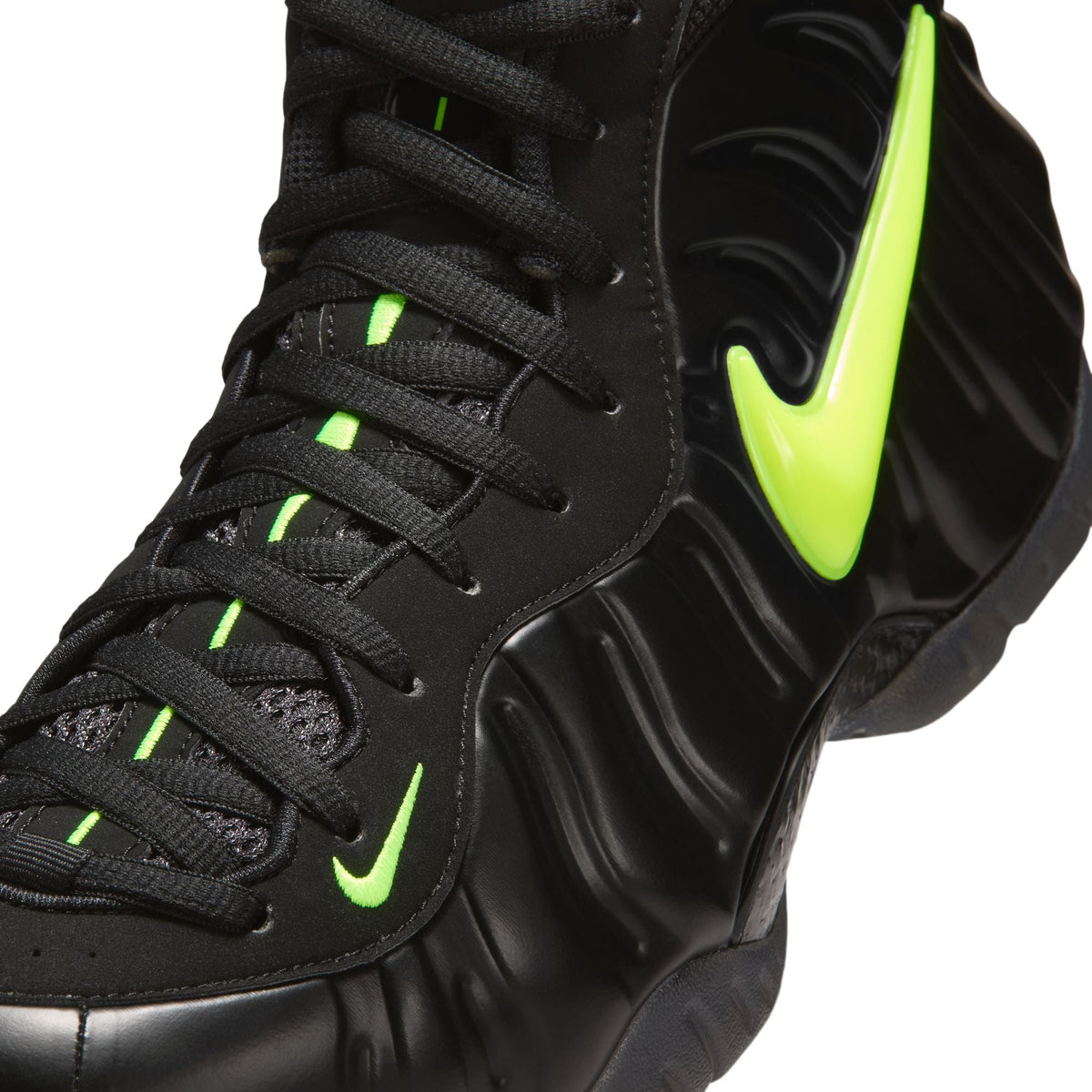 Nike men's Air Foamposite Pro sneakers in black and voltage, featuring a sleek design and durable construction.