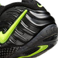 Nike men's Air Foamposite Pro sneakers in black and Voltage with sleek design and textured upper, shown from side angle.