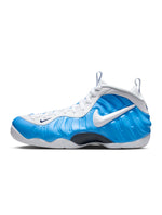 Nike Mens Air Foamposite Pro University Blue sneakers, featuring a sleek design and bold blue color, displayed on a clean background.