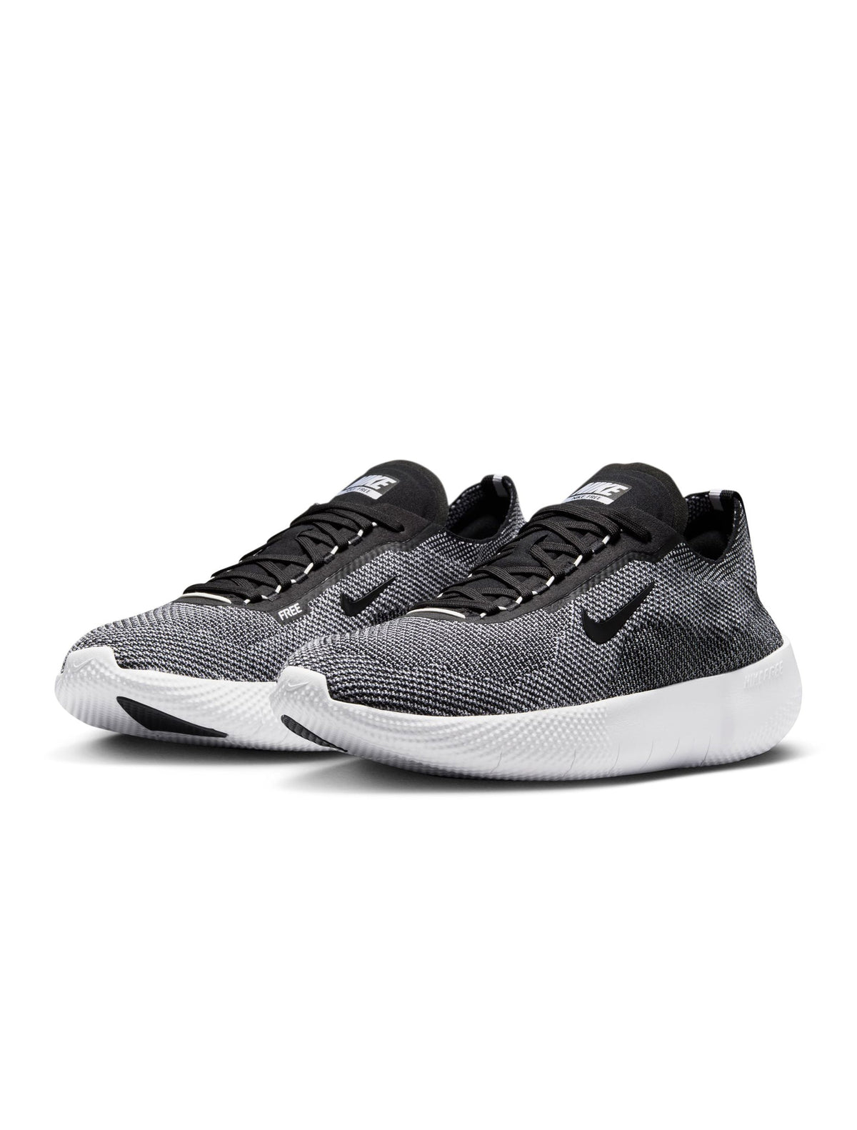 Black and white Nike men's Free 2025 sneakers featuring sleek design and breathable material, displayed on a neutral background.