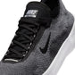 Nike men's Free 2025 black and white athletic shoes, lightweight footwear with breathable design for active wear.