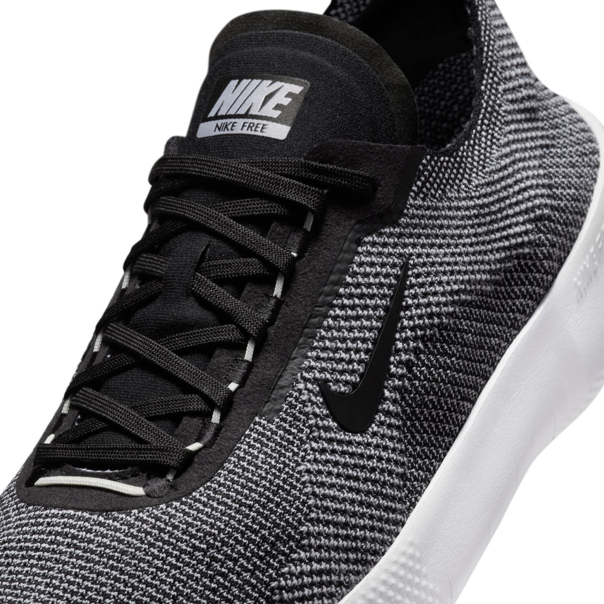 Nike men's Free 2025 black and white athletic shoes, lightweight footwear with breathable design for active wear.