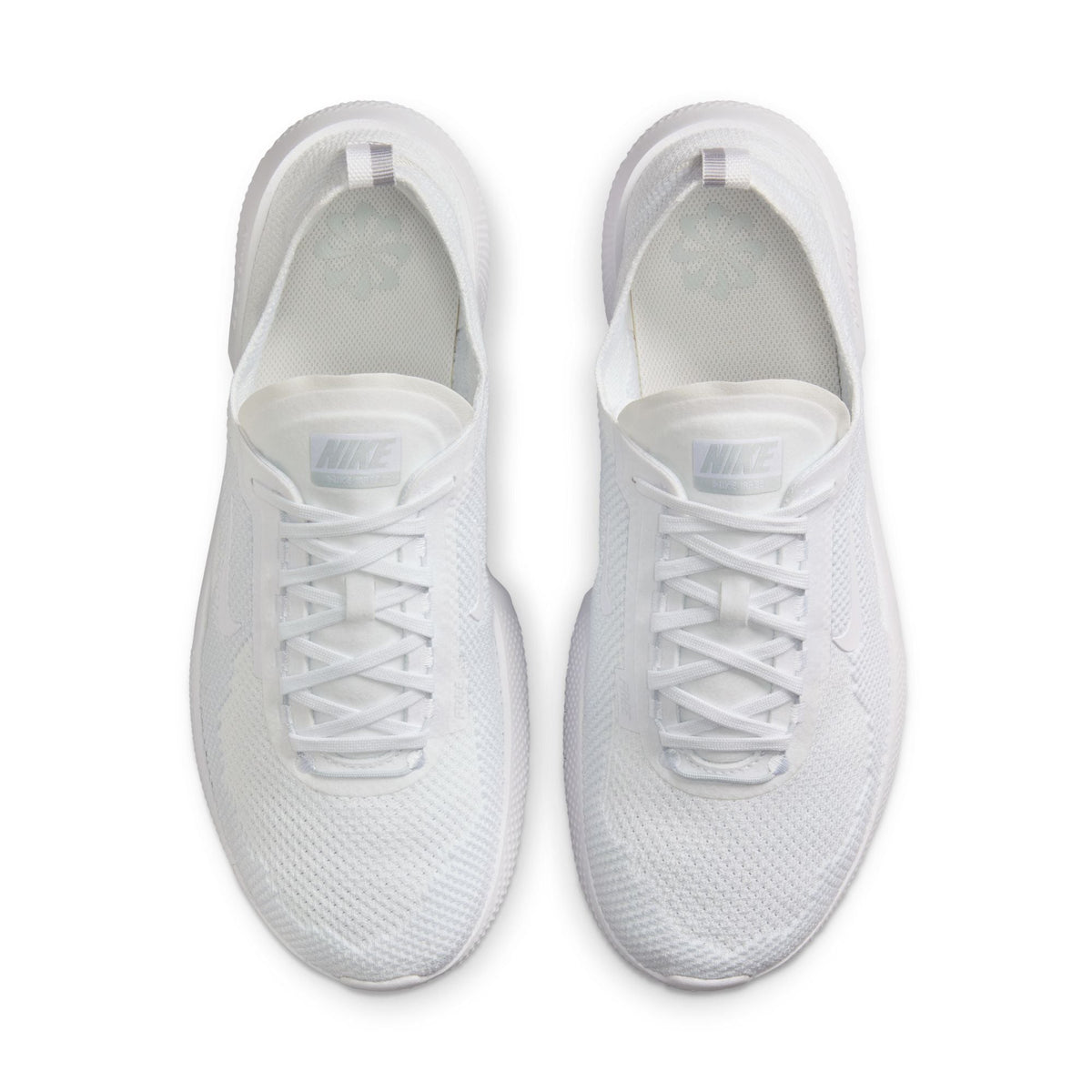 Nike men's Free 2025 white athletic shoes with breathable mesh and cushioned soles, featuring sleek design and Nike branding.