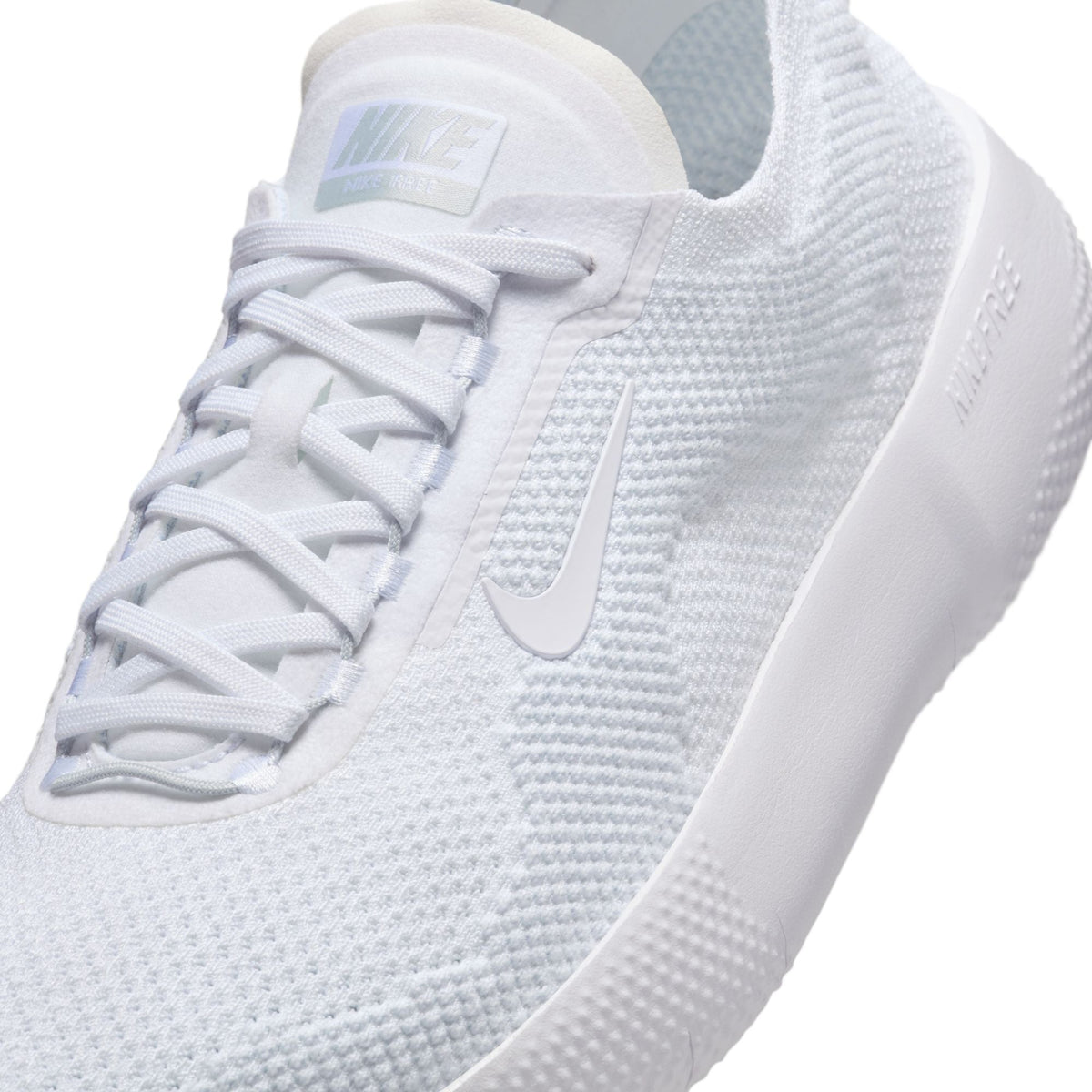 Nike men's Free 2025 white sneakers, lightweight athletic footwear with breathable mesh and cushioned sole.