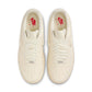 Nike Women's Air Force 1 Low sneakers in Coconut Milk color, featuring classic design and white leather upper, displayed on a plain background.