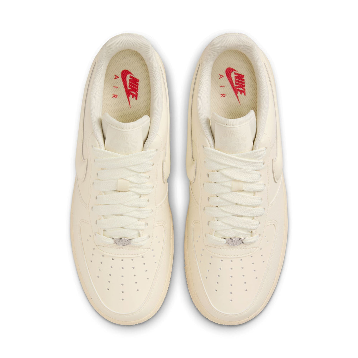 Nike Women's Air Force 1 Low sneakers in Coconut Milk color, featuring classic design and white leather upper, displayed on a plain background.