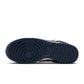 Nike Men's Dunk Low Retro Blue Legend sneakers in navy and white with white laces, shown from a side angle.