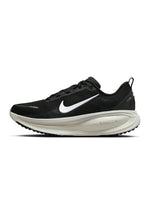 Black and white Nike Men's Vomero 18 running shoes displayed from the side