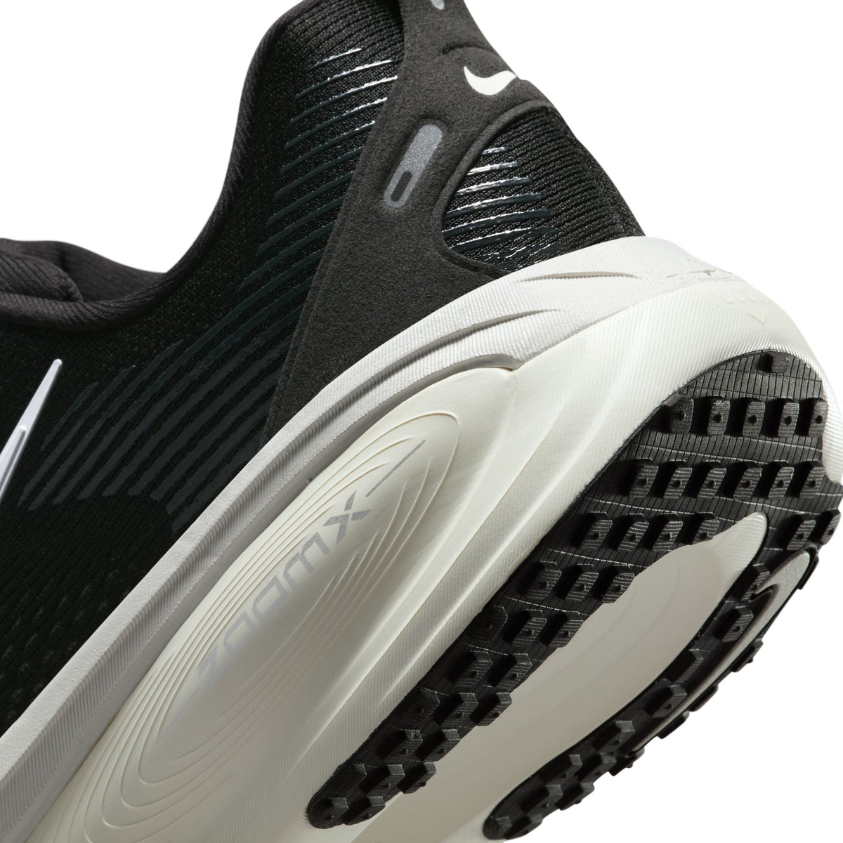 Black and white Nike men's Vomero 18 running shoes, side view