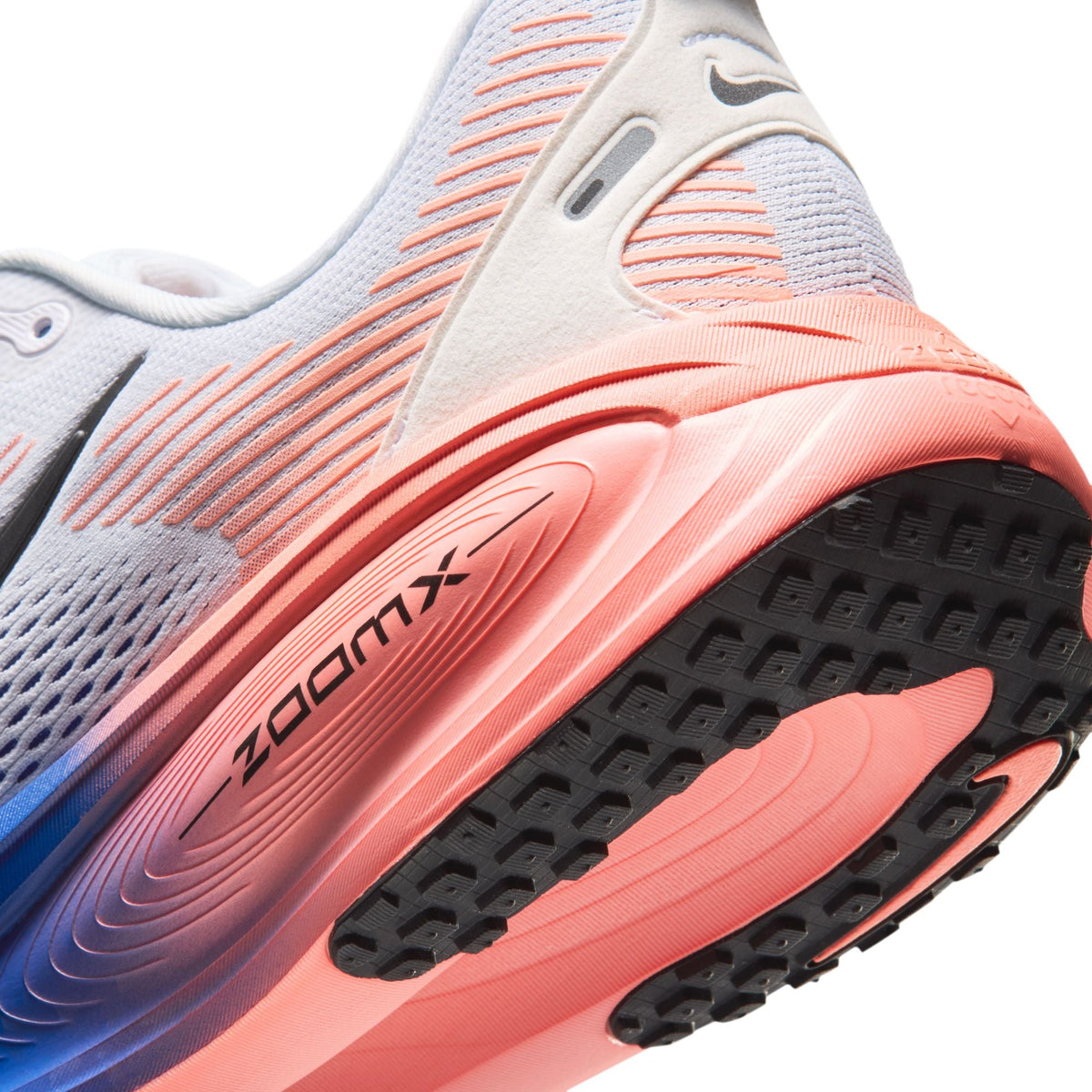 Nike men's Vomero 18 running shoes in white and blue with breathable mesh upper and cushioned sole, displayed on a plain background.