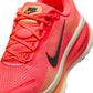 Nike Womens Vomero 18 Hot Lava running shoes, vibrant orange and pink athletic footwear for women, displayed on a plain background.