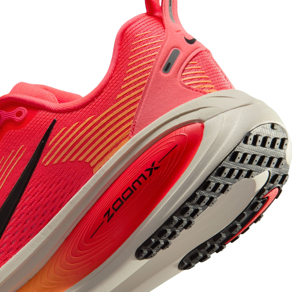 Nike Womens Vomero 18 running shoes in Hot Lava color, showcasing breathable mesh and cushioned sole for comfort.