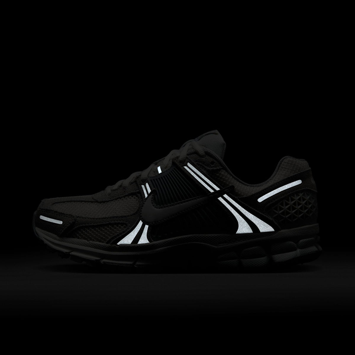 Nike Women's Zoom Vomero 5 running shoes in Pure Platinum, with lightweight design and sporty style, worn by a model.