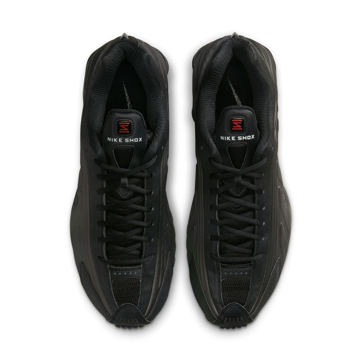 Black Nike Men's Shox R4 sneakers, side view with visible Shox cushioning columns