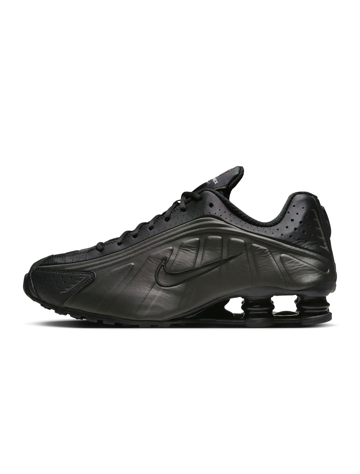 Men’s Nike Shox R4 footwear in black with signature segmented sole design