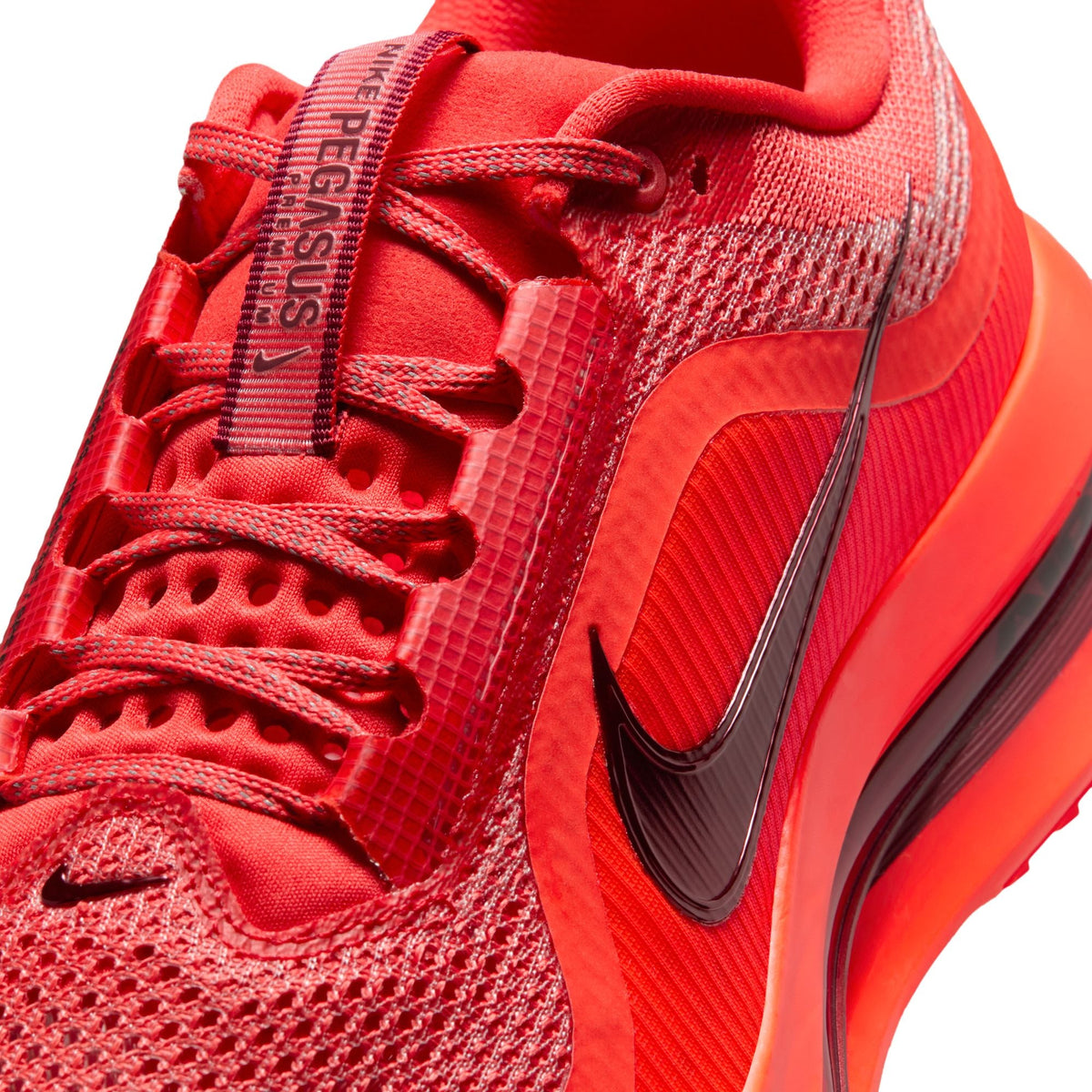 Nike Men's Pegasus Premium sneakers in Light Crimson, side view.