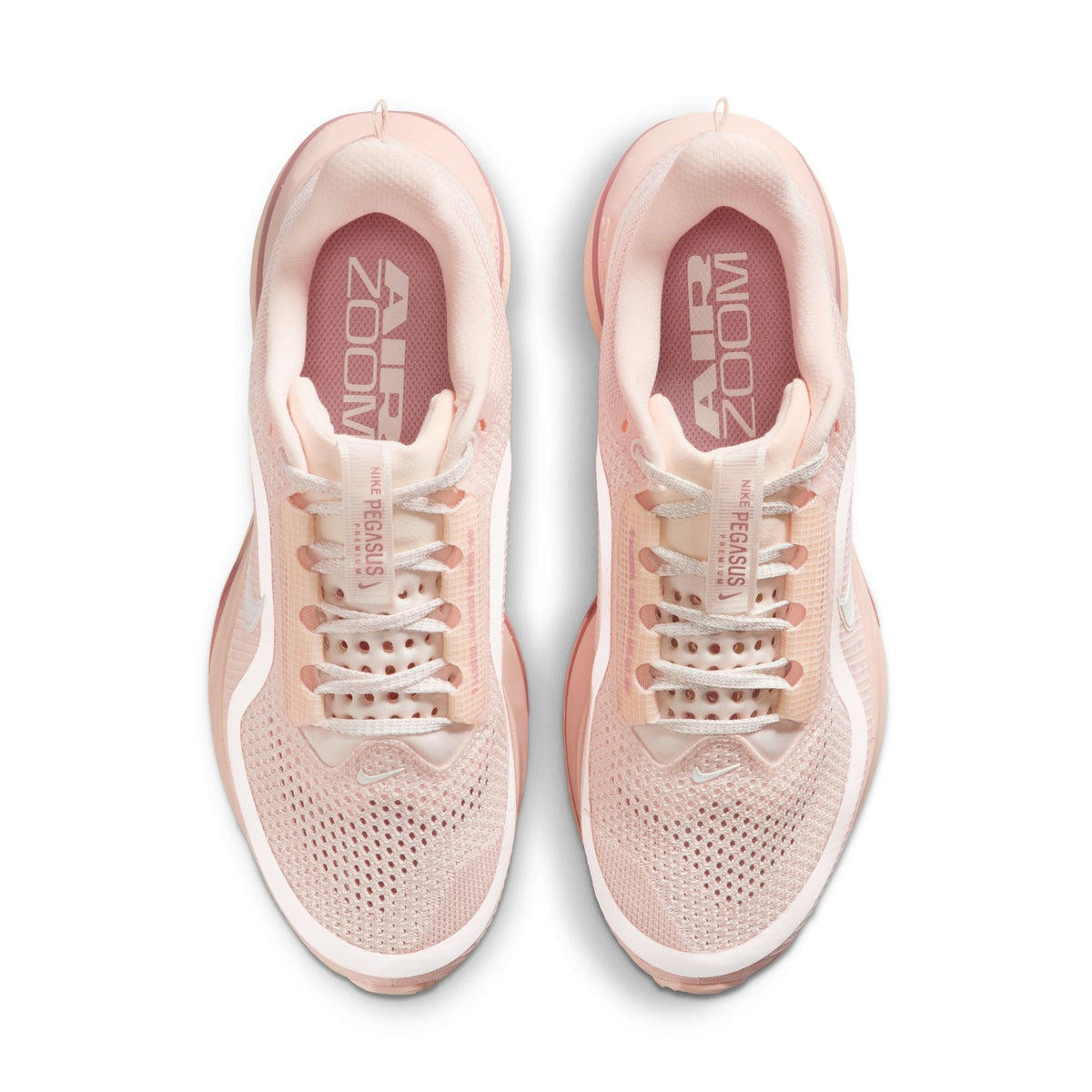 Nike Womens Pegasus Premium Guava Ice running shoes, pink and white athletic footwear with Nike branding and breathable mesh design.
