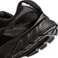 Black Nike Women's V5 RNR footwear with sleek design and Nike branding, showcased in a natural outdoor setting.