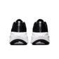 Men's Nike Vomero Plus footwear in black and white, side view with visible cushioned sole