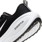 Black and white Nike men's Vomero Plus sneakers viewed from the side, showing layered mesh and cushioned sole