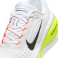 Nike men's Vomero Plus shoes in white with Barely Volt accents, side view.