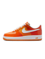 Nike men's Air Force 1 '07 LV8 sneakers in Safety Orange, side view aviator-style footwear.