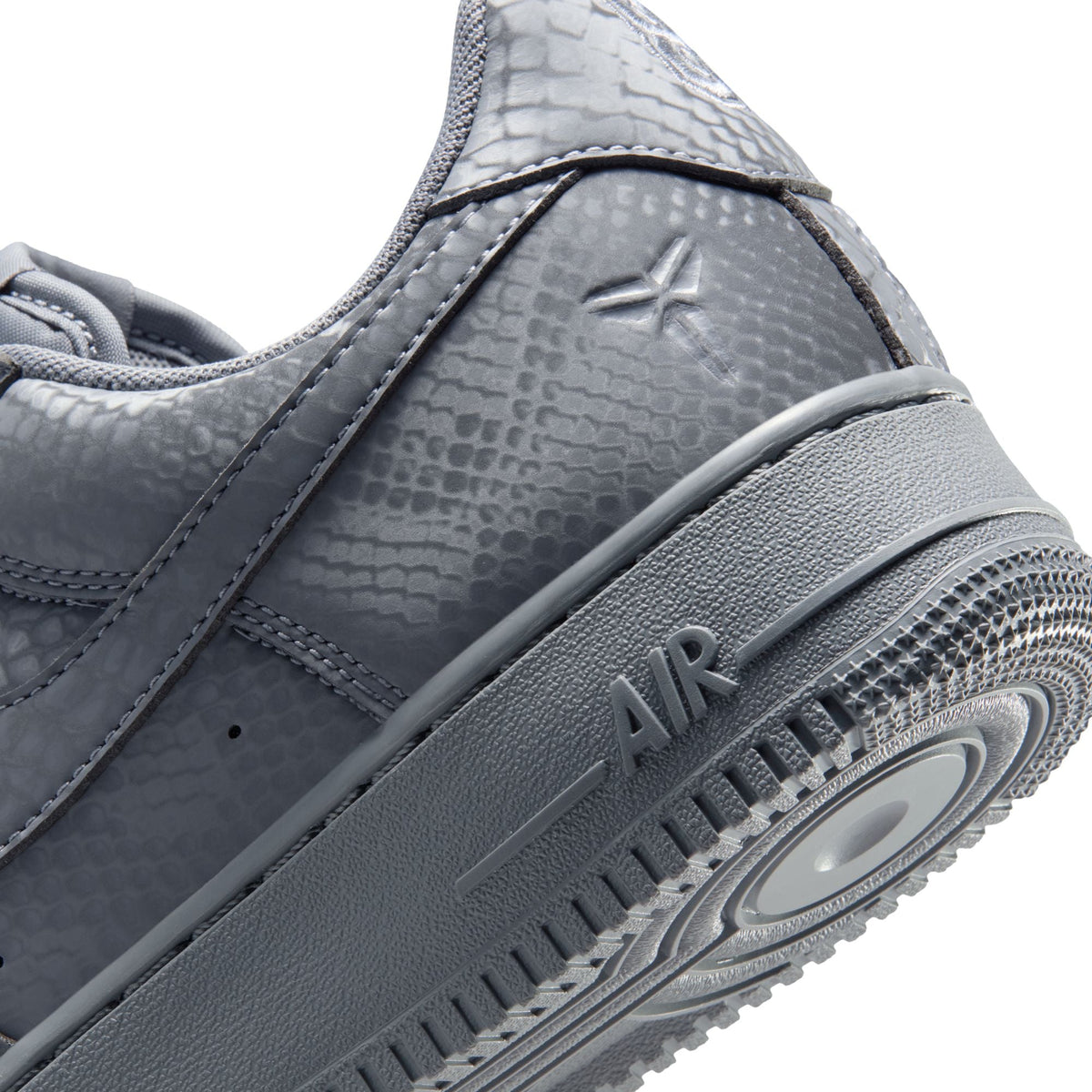Nike men's Kobe Air Force 1 Low sneakers in Wolf Grey, displayed on a shoe display with a white background.