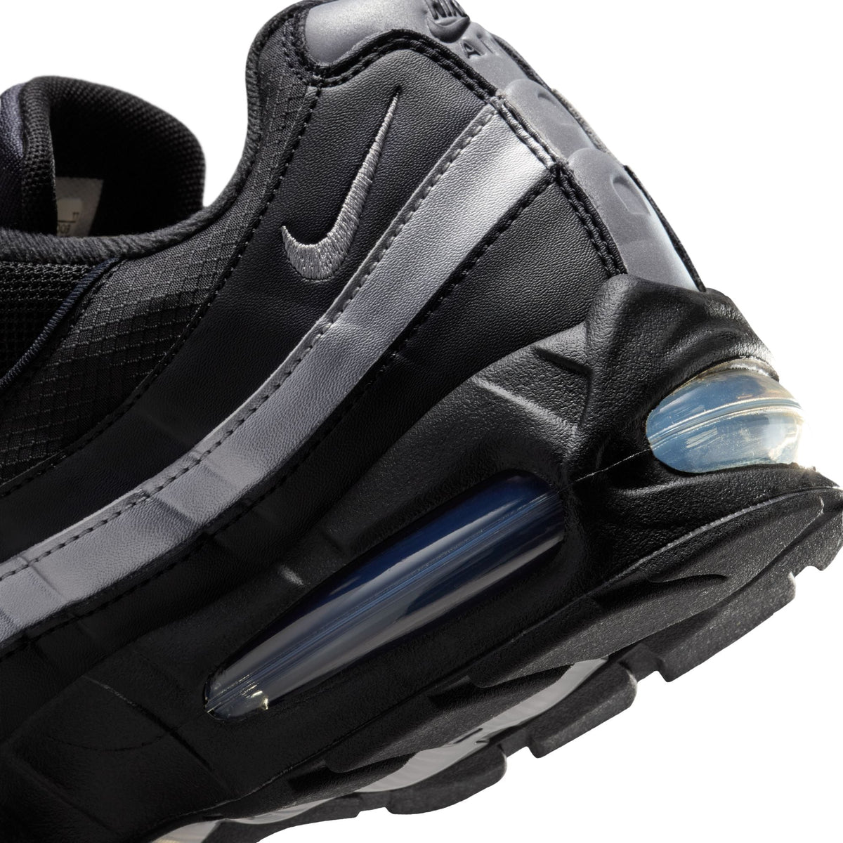 Nike Mens Air Max 95 Big Bubble black and metallic silver sneakers, showcasing the iconic design and stylish color accents.