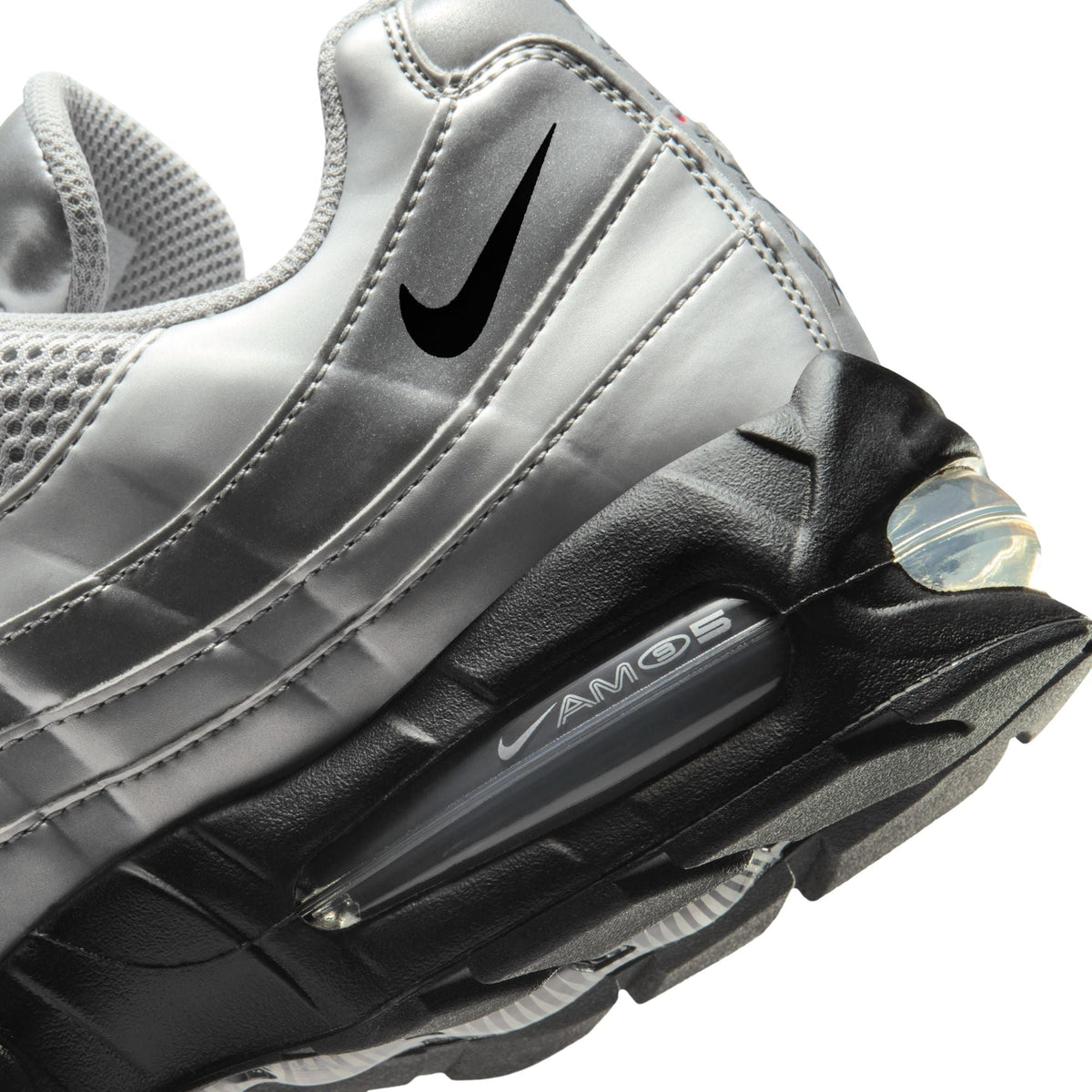Nike Men's Air Max 95 sneakers in metallic silver, side view...