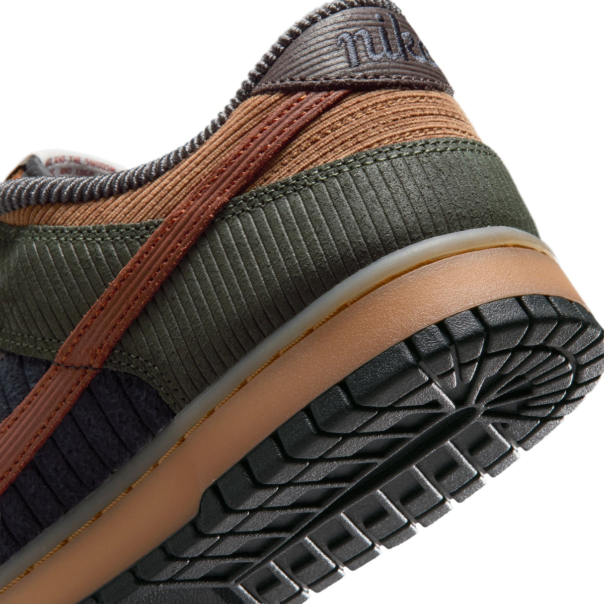 Nike men's Dunk Low Retro Premium sneakers in British Tan with tan and brown leather, featuring Nike branding and stylish design.
