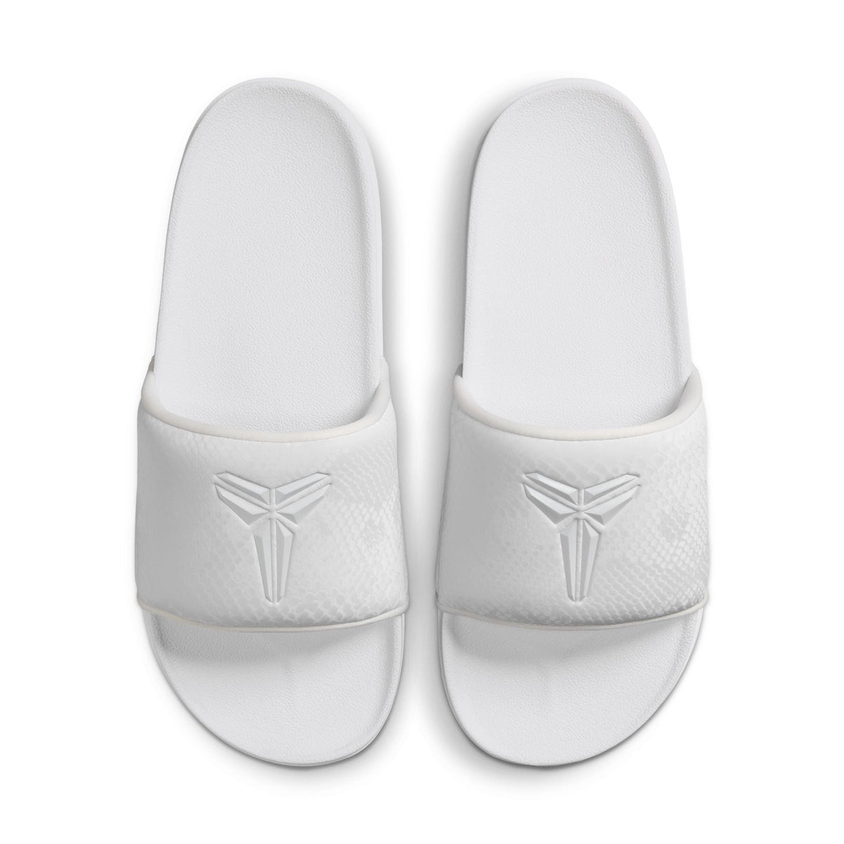 White Nike men’s Kobe Offcourt slides by Denim Exchange, side view of slip-on footwear.