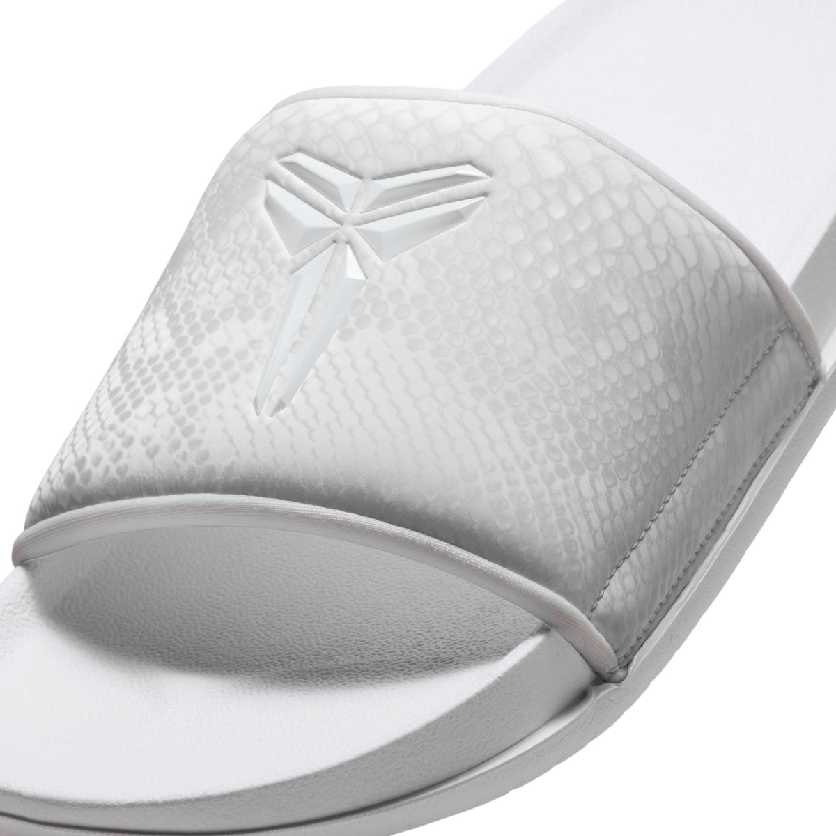 Nike men's Kobe Offcourt slides in white, side view.